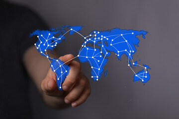 Conceptual image of a hand interacting with a digital world map, illustrating global network connections, data, communication, and technology.