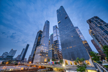 New York City - June 13, 2025: Nighttime perspective of High Line with visitors walking and modern Hudson Yards architecture