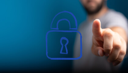 Stock photo of a hand selecting a digital lock icon, representing data security, privacy, and...