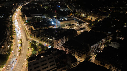 Aerial drone night shot of illuminated Athens urban cityscape, Attica, Greece