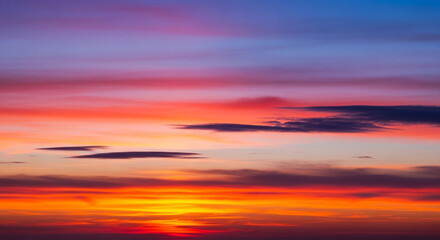 Fototapeta premium Vibrant sunset paints the sky with fiery hues, blending orange, red, and purple in a breathtaking display of natural beauty