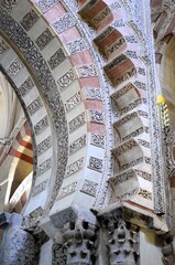 Cordoba, Spain 03.27.2019: Ceiling with double arches of white stone and red brick at the Prayer...