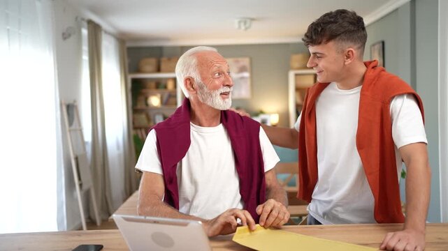 Grandson sharing good news with grandfather at home