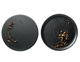 Two black slate plates, top-down view, one with sprigs and peppercorns, the other with mixed spices