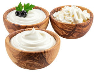 Three wooden bowls of creamy dairy products, garnished with olives and herbs
