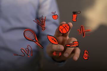 A person interacts with a futuristic digital interface displaying various sports and health icons, symbolizing modern wellness and active lifest