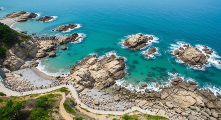 Aerial view of rocky coastline and turquoise ocean waters under sunlight