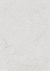 Close-up of a smooth, light gray textured surface with subtle scratches and faint marks.