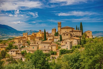 Rustic stone homes surrounded by vibrant greenery beneath a bright azure sky, showcasing classic Mediterranean design and peaceful scenery.
