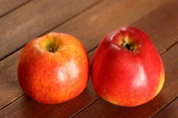 Minimalist still life of red apples on wooden table