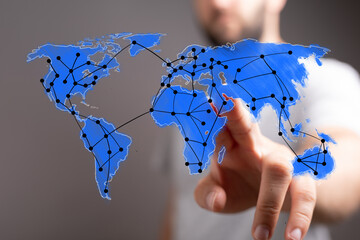 Abstract concept of global business, communication, and digital technology. Hand interacting with world map network for data and connection.