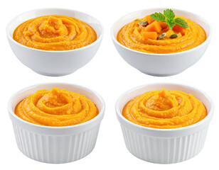 Four small white bowls of orange pumpkin puree, garnished with pumpkin pieces and seeds