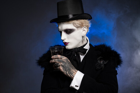 Fototapeta Young man in striking Halloween costume embodies elegance and mystique at night celebration
