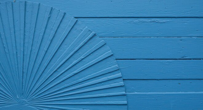 Blue abstract wooden texture featuring a fan-shaped radial pattern against horizontal parallel planks background