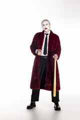 Epic young man in vibrant Joker costume for Halloween celebration brings artistic flair to the night