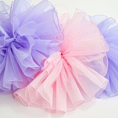 Soft pastel pink and lavender sheer fabric bows decoration.