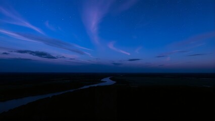 Serene twilight river landscape with starry sky and wispy clouds