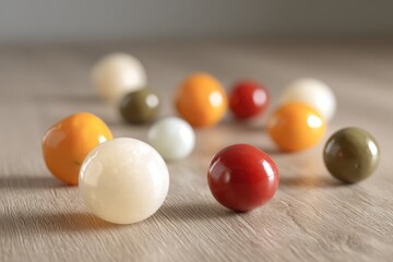 Colorful orbs scattered on a light-brown surface