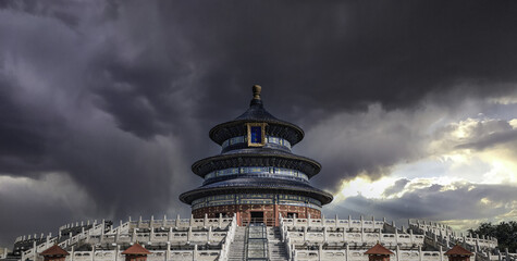 The golden-roofed Temple of Heaven in Beijing displays symmetrical architecture, intricate wood...