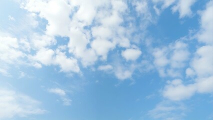 Fototapeta premium Serene blue sky with fluffy white clouds overhead