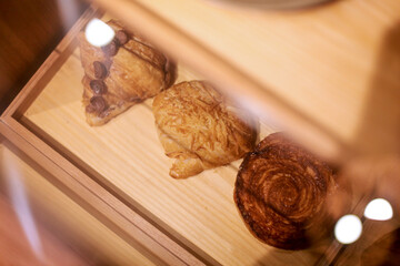 Freshly baked croissants on a wooden tray