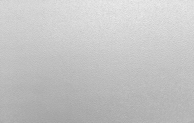 Detailed close-up photograph of a light gray painted surface