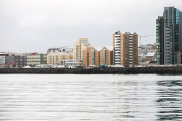Fototapeta premium Reykjavik, Iceland, a tranquil harbor scene along a rocky breakwater