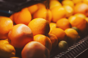 Bright oranges fill a market display, inviting shoppers to enjoy their juicy sweetness and vibrant color on a sunny afternoon
