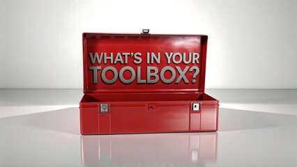 "Open Red Metal Toolbox with Text 'What’s in Your Toolbox?' on Reflective Surface"