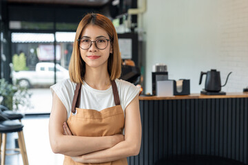 Happy barista in apron proudly welcomes customers with passion for brewing coffee at a new cafe and small business coffee shop in the morning. Owner new business sme.