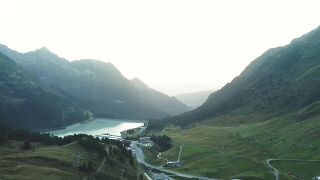 Smooth aerial shot flying over the Speichersee in K&uuml;htai, framed by alpine mountains. Ideal for infrastructure, tourism or landscape visuals.