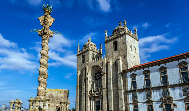 Historic pillory in front of Cathedral in Porto, view with Cloister and Chapter House building, Portugal