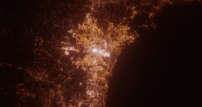 Sendai (Japan) aerial view at night. View on modern city from space. Camera is zooming in, rotating counterclockwise