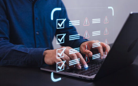 Businessman Managing Digital Compliance Audit Checklist on a Laptop