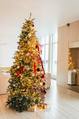 Merry Christmas Xmas happy holidays. Classic decorated Christmas tree with golden red ornaments decoration ball and garland lights. Christmas tree with red gold ornaments. Christmas eve at home