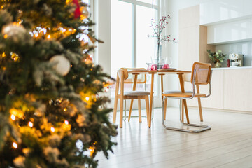 Classical Christmas decorated interior kitchen. Modern classic style interior design apartment dining room and Christmas tree with red golden ornament decorations. Christmas eve at home