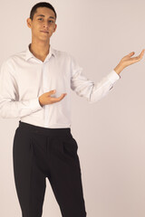 Man is standing and gesturing with open hands, seemingly presenting.