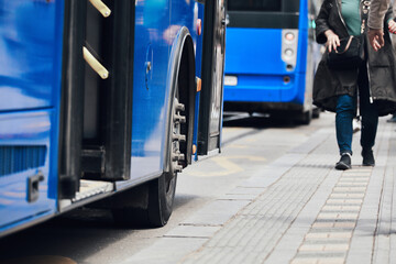 Blue bus for public transportation on city streets.