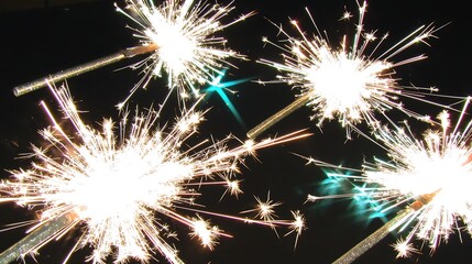 Dark clear sky filled with sparkling fireworks bursts, vibrant colors radiating in arcs