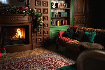 Classical Christmas decorated interior living room with fireplace. Christmas tree with red golden...