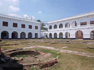 Historic old building with the big door and hallway. Blu sky white beautyfull cloud