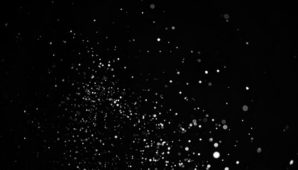 Abstract black background with scattered white particles