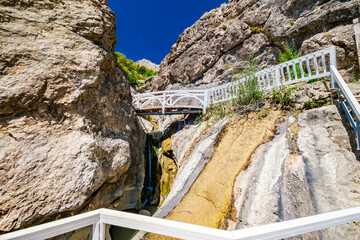 wooden stairs and passageways on hiking route in mountains with waterfalls