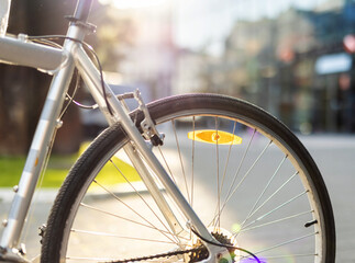 Unrecognizable man with bike on the street. Low angle view of a man walking down the street pushing bicycle while going to work.