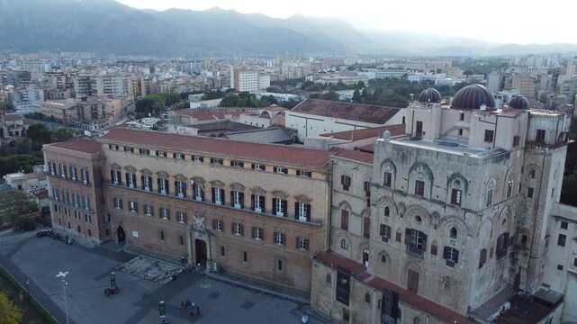 Aerial 4k drone footage of Palazzo dei Normanni in Palermo, Sicily, Italy, showcasing the historic royal palace, Cappella Palatina, surrounding gardens, and panoramic views of the city.
