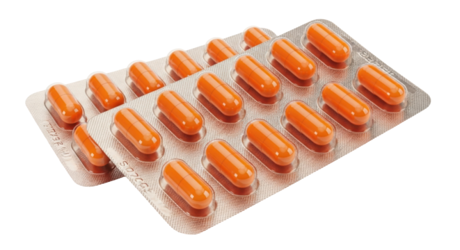 Isolated blisters with capsules of medicine in a package, orange color, in front of camera