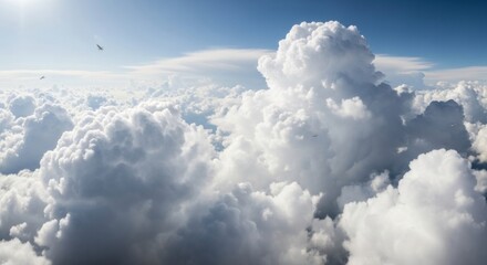 Fototapeta premium Aerial view of fluffy white cumulus clouds against a blue sky with birds flying above the cloudscape