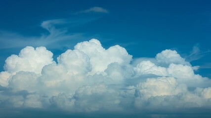 Growing cumulus formation merging under high-altitude winds in blue sky, with cirrus clouds - Powered by Adobe