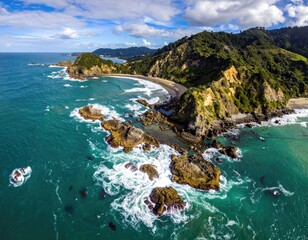 Fototapeta premium Coastal panorama with rocky outcrops, waves, and green hills