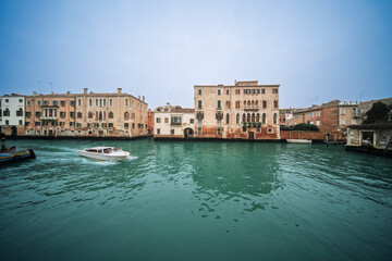 Motorboat glides through turquoise waters in Venice's Cannaregio